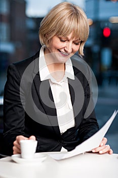 Corporate women in cafe with reports