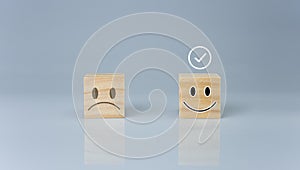 The correct sign is on a wooden block with a smiley icon. represents feedback rating and positive customer review, Satisfaction