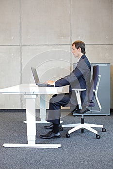 correct sitting position at workstation - man in suit -