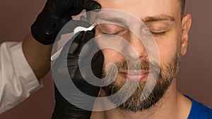 Correcting shape of eyebrows to male client