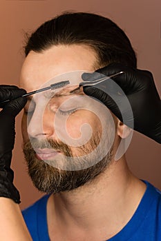 Correcting shape of eyebrows to male client