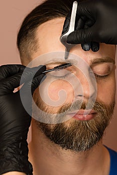 Correcting shape of eyebrows to male client