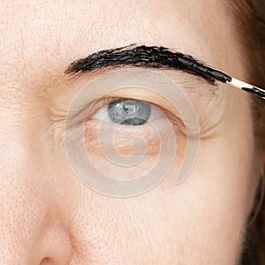 Correction of eyebrows and modeling at home, eyebrow coloring henna tattooing, permanent makeup closeup