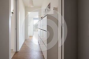 Corridor with chest of drawers and city view