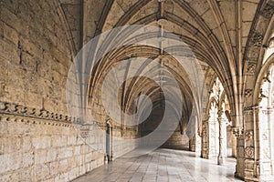 Corridor of the cloister in the Jeronimos Monastery with arched stone interior in Lisbon, Portugal.
