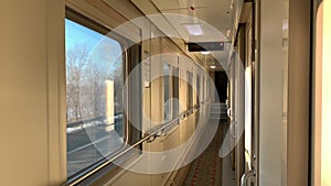 In the corridor of the compartment car of the train in motion, flashing winter landscape outside the window