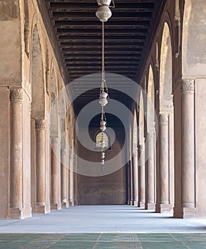 Corridor at the courtyard of the Mosque of Ahmad Ibn Tulun framed by huge decorated arches, Cairo, Egypt
