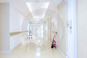 Corridor in hospital with vital signs patient monitor and fire exit sign