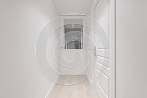 Corridor of a house with smooth white painted walls