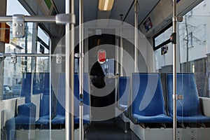 Corridor inside passenger trains or light rail tram with blue fabric seats of German railway train system.