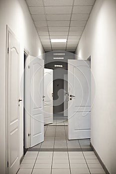 Corridor with many doors open