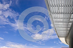 Corridor with modern office building roof with blue sky and whit