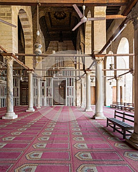 Corridor at mosque of Sultan Moaayad, ending with colorful marble wall and wooden door, Cairo, Egypt photo