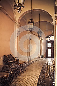 Corridor of an old castle with arches and pendant lamps. Image for your creative design