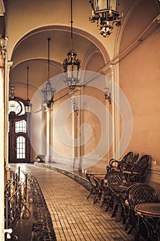 Corridor of an old castle with arches and pendant lamps. Image for your creative design