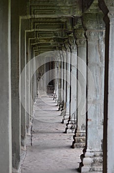 A corridor of pillars in an ancient temple.