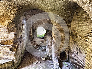Corridor with Roman vault inside an ancient building in the archaeological excavations of Ostia Antica in Rome
