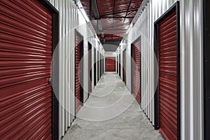 Corridor of self storage unit with red doors. Rental Storage Units