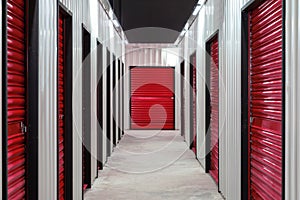 Corridor of self storage unit with red doors. Rental Storage Units