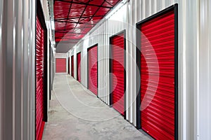 Corridor of self storage unit with red doors. Rental Storage Units