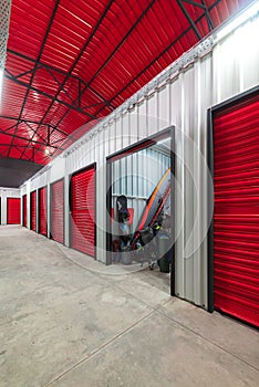 Corridor of self storage unit with red doors. Rental Storage Units