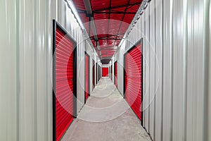 Corridor of self storage unit with red doors. Rental Storage Units