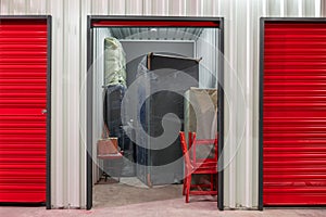 Corridor of self storage unit with red doors. Rental Storage Units