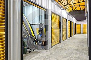 Corridor of self storage unit with yellow doors. Rental Storage Units