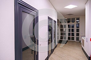 A corridor in an urban-type office building. Modern interior of the lobby of an office building with glass doors and clean white