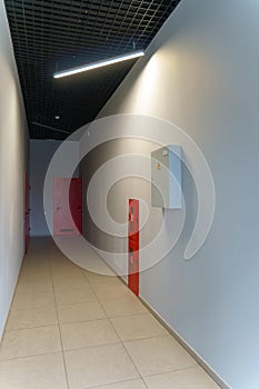 A corridor in an urban-type office building. Modern interior of the lobby of an office building with glass doors and clean white