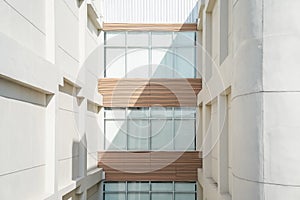 The corridors between buildings are provided with full height windows with white curtains