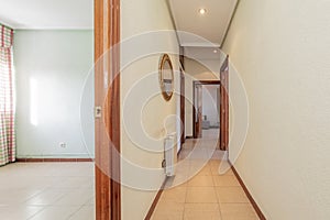 Corridors of an empty house with sapelly wood carpentry on doors, moldings and skirting boards