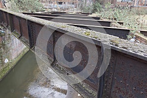 Corroded girders across urban river