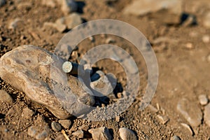 Corroded gun sleeve in desert