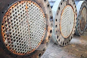 Corrosion, refinery heat exchanger chiller tubes with flange system. Two Industrial heat exchangers or boiler rusty tube