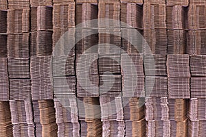 Corrugate cardboard tied with white plastic rope. Corrugated paper single wall. Corrugated fiberboard. Linerboard board. photo