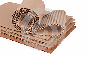 Corrugated cardboard layer pads and flexible singleface corrugated paper in roll isolated on white. Environmentally