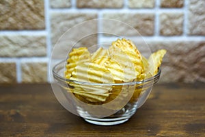 Corrugated chips inside a bowl close up