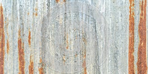 Corrugated galvanized rusty metal sheet background with old aged rust texture on zinc tin or iron steel grunge wall panel photo