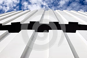 Corrugated iron roof against cloudy sky