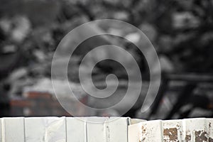 Corrugated metal fence on the background of the dismantled building