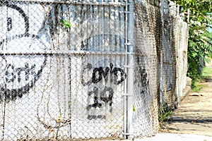 A vandalized metal fence on the corner photo