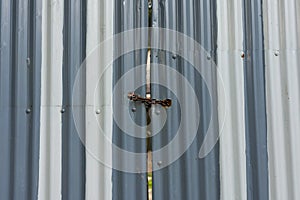 Corrugated metal gate padlocked