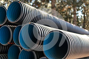 Corrugated water pipes of large diameter prepared for laying, copy space