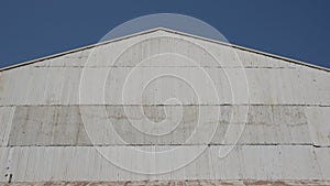 Corrugated zinc facade soars into blue sky