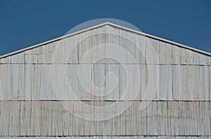 Corrugated zinc facade soars into blue sky