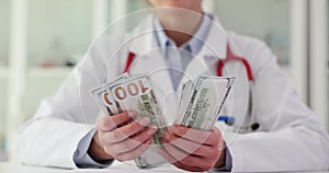 Corrupt doctor counts money in clinic