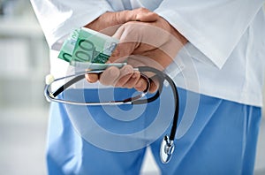 Corrupt doctor with stethoscope in hospital