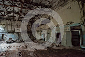 Corrupted basketball indoors court in the abandoned school building located in the Chernobyl ghost town