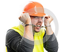 Corrupted constructor man trying to escape biting handcuffs